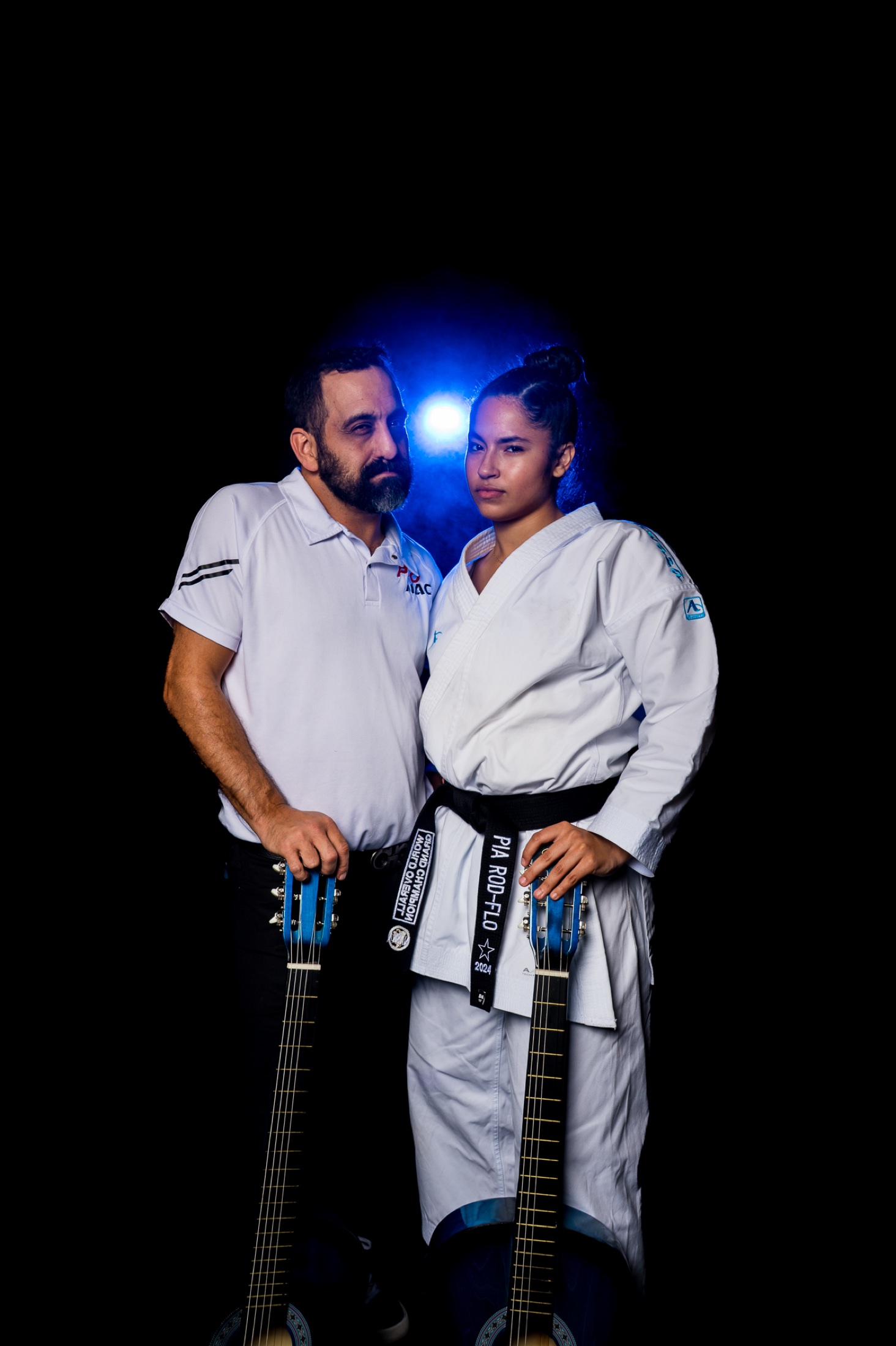 Black belt Grand Champion and Joey Perry holding Memphis Open Blue Guitars